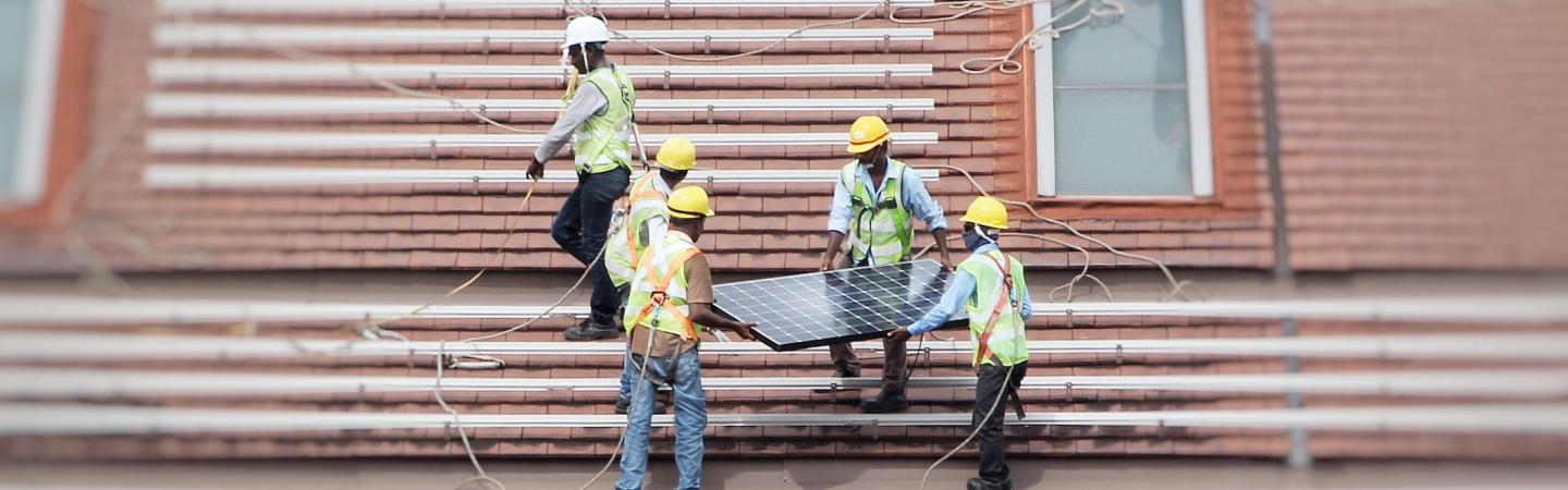 workers installing solar panels