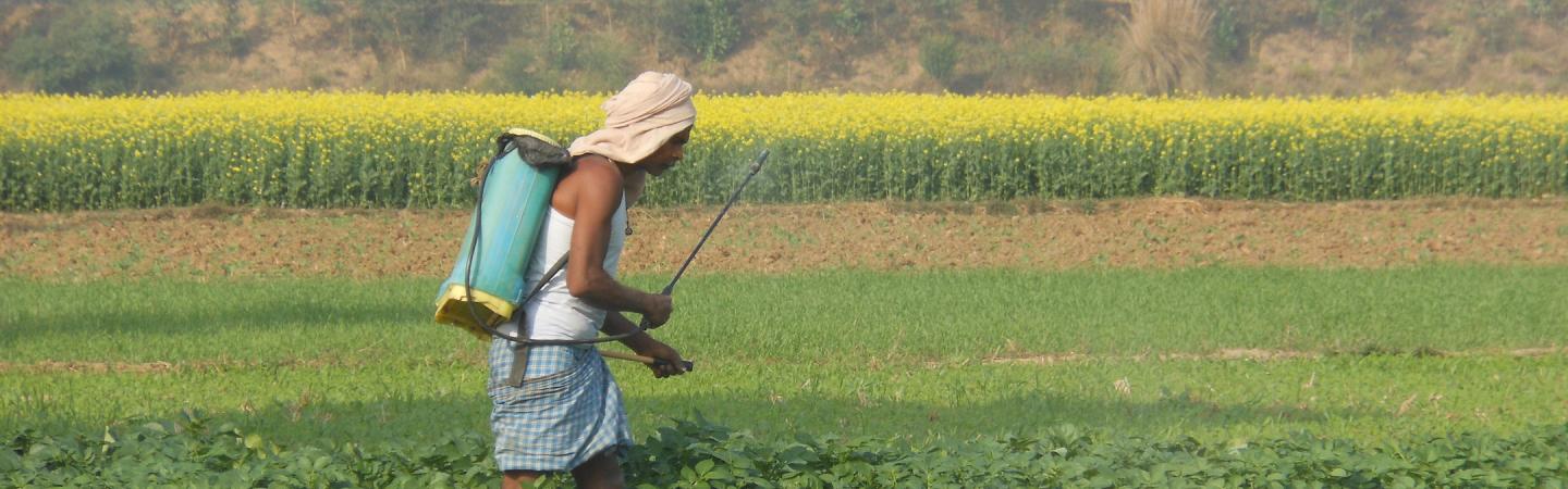 a farmer spraying fertilizer