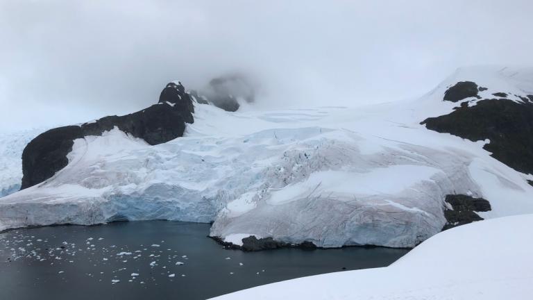 Glacier breaking off into ocean