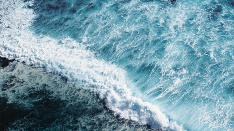 Aerial photograph of an ocean wave crashing