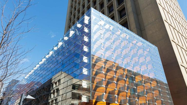 The airy exterior of the Moghadam Building, designed by AW-ARCH to complement and extend the Green Building’s Brutalist tower, is sheathed with an innovative system of wood composite overlaid with bracketed glass panels that reflect the surrounding trees and green space.