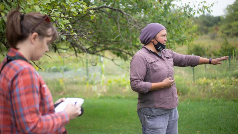 ESI Journalsim Fellow Nora Hertel (left) takes notes during a tour with Jessika Greendeer, seedkeeper and farm manager for Dream of Wild Health, a Native American-led nonprofit with a farm just outside the Twin Cities in Hugo, Minnesota.