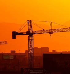 Construction cranes in Phoenix on July 13, 2023, the 14th day in a row of temperatures 110 degrees or more.