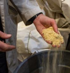 University of Maine engineer Ian Toal holds a handful of sawdust from a nearby mill at a research center in Old Town. This and other "waste wood" products are abundant in heavily forested Maine and are eyed as a basis for renewable heating fuels.