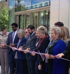 President Sally Kornbluth, fifth from left, joins Governor Maura Healey and members of the federal government and Cambridge community for a ribbon cutting at the new John A. Volpe National Transportation Systems Center.