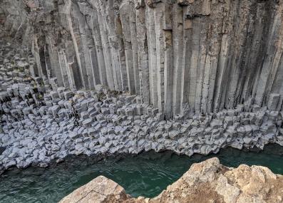 basalt rock formation over river